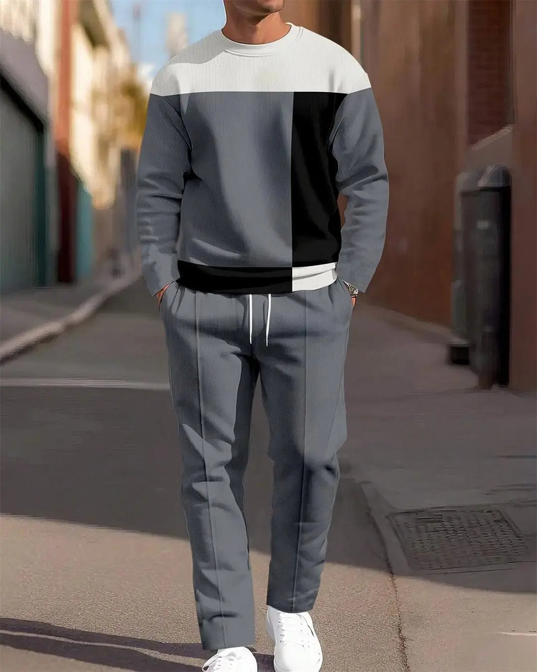 Ensemble sweat à carreaux et pantalon pour hommes, comprenant un sweat-shirt gris et noir à empiècements contrastants, avec des finitions blanches au niveau du col, de la ceinture et des poignets.
