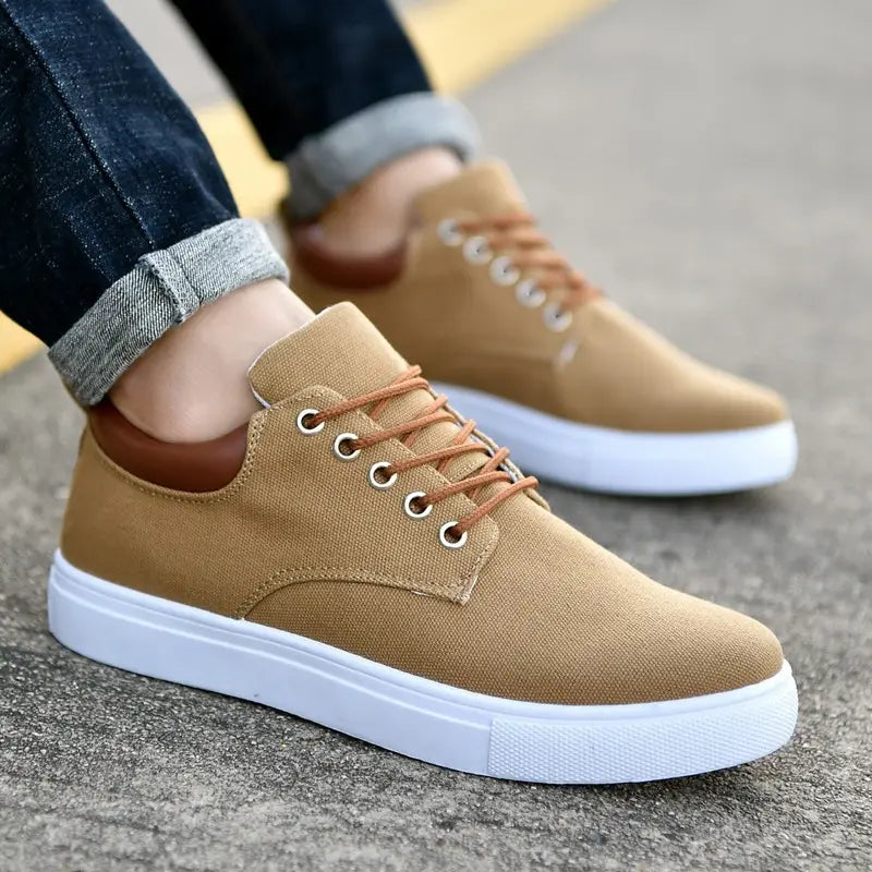 Men’s breathable casual sport shoes in tan canvas with brown laces and white rubber soles.