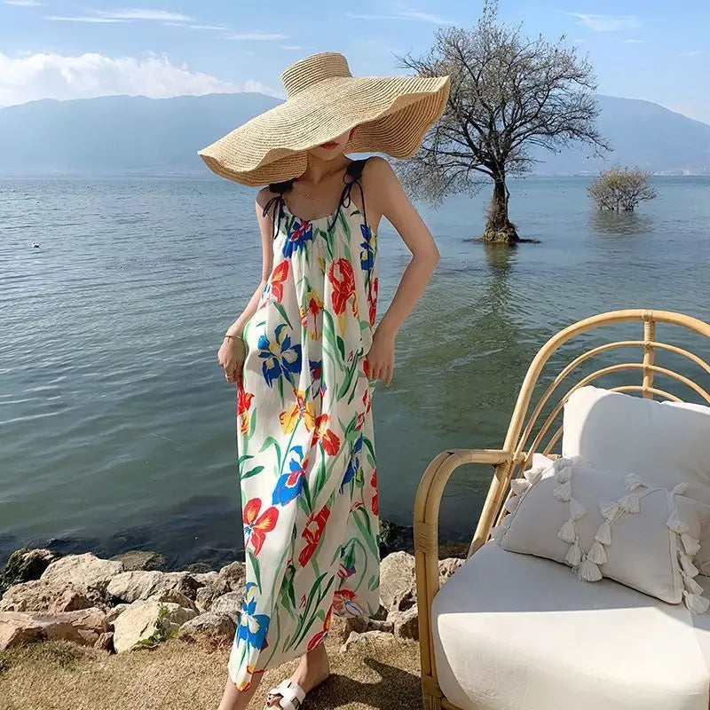 a flowing off-white floral mesh maxi dress with a retro slip silhouette featuring vibrant red, blue, and green floral patterns