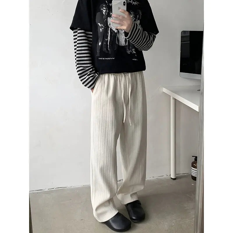 Off-white ribbed cotton wide leg drawstring trousers with a comfortable waistband suitable for casual wear.