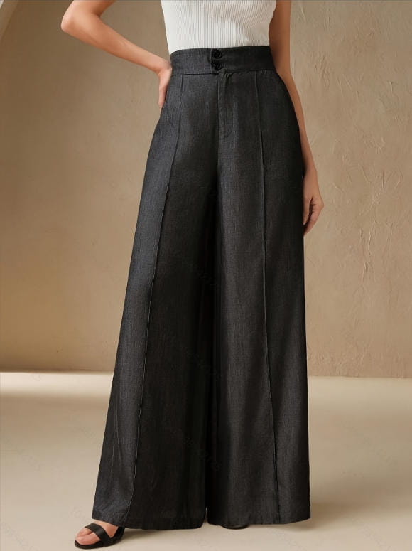 Black high waisted wide leg trousers made of subtle textured fabric with button closure.