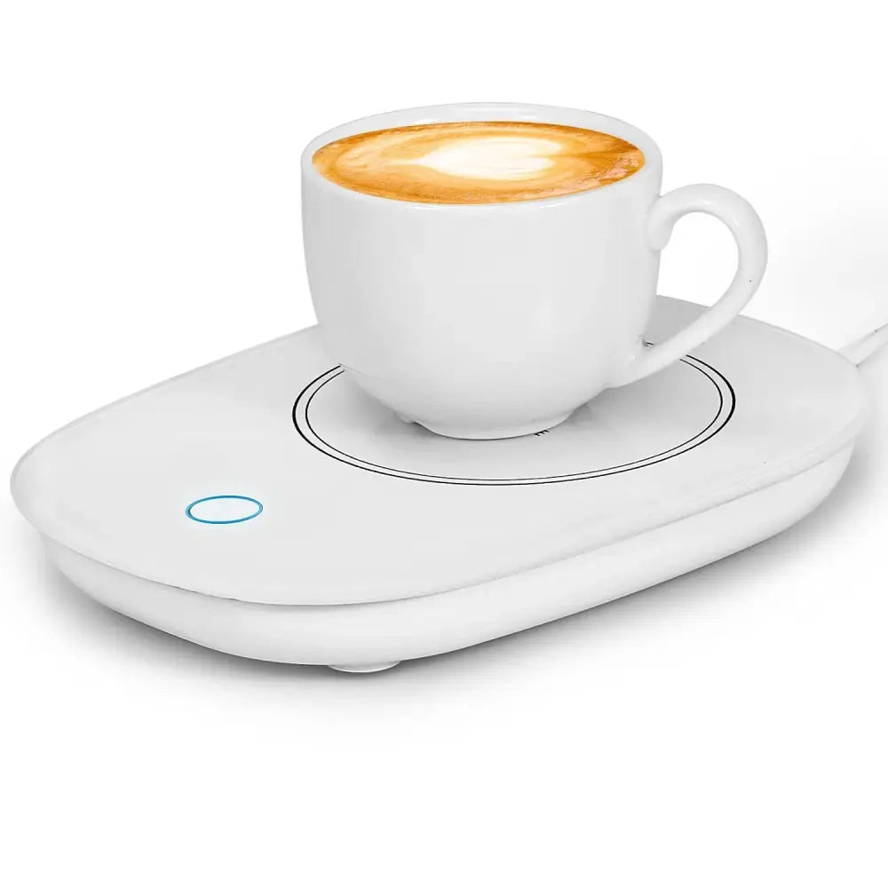 White ceramic coffee cup with latte art on a smart electric coffee mug warmer with auto shut and blue indicator light