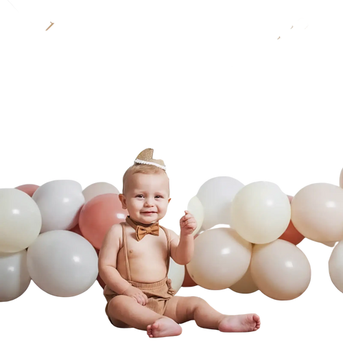 Gold foil happy birthday banner with numbered photo frames hanging above a baby for 1st birthday photo garland