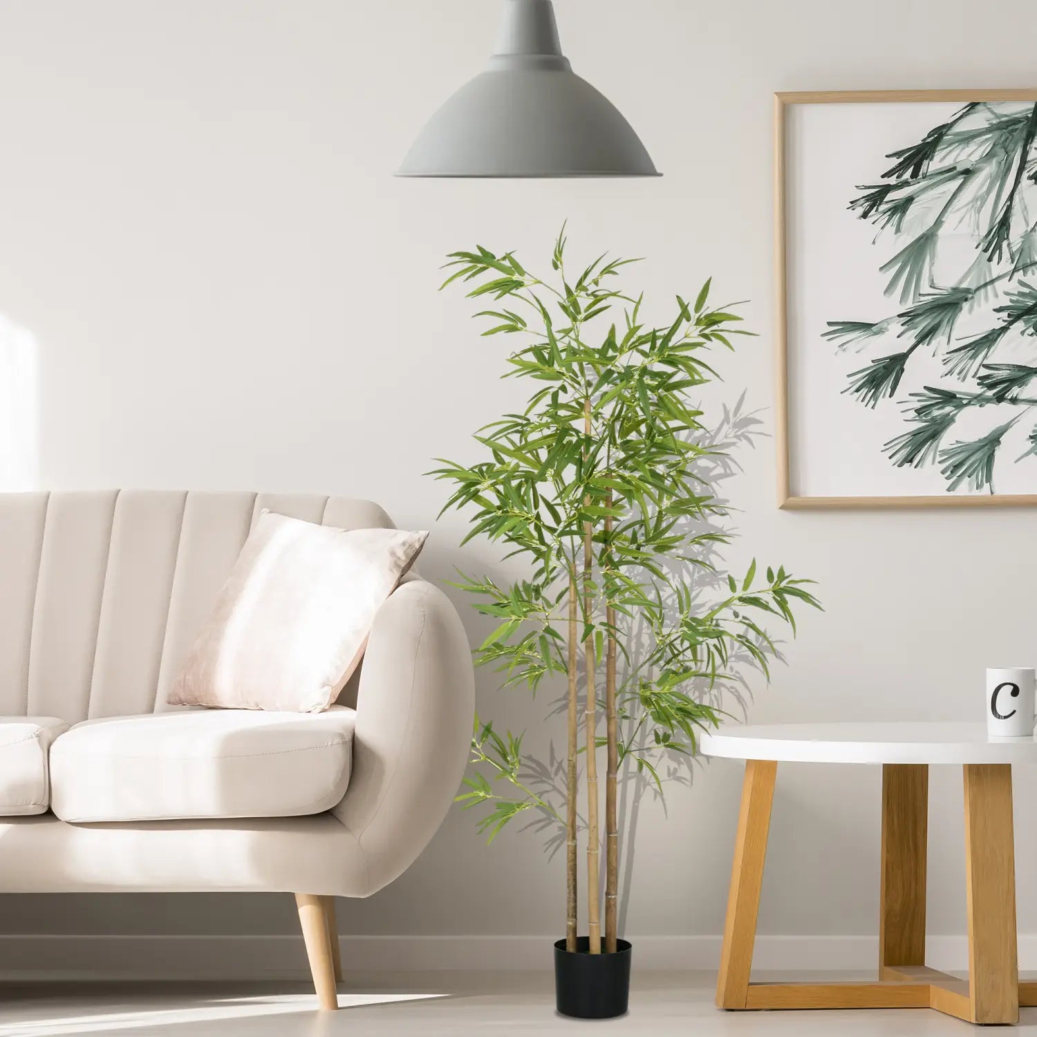 Árbol artificial de bambú de 6 pies con hojas verdes exuberantes y tallos marrones delgados en una maceta negra elegante para uso en interiores.