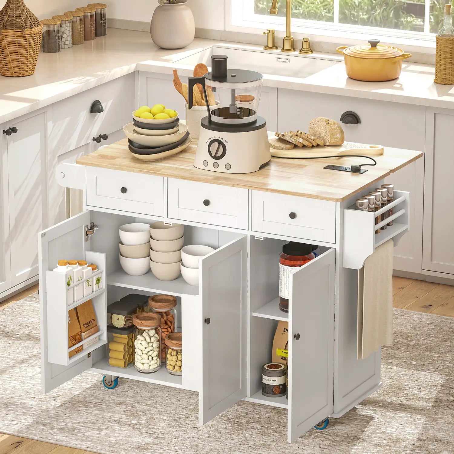 White kitchen island cart with drop leaf and charging station featuring light wood countertop, multiple drawers and cabinets, and rolling casters for mobility.