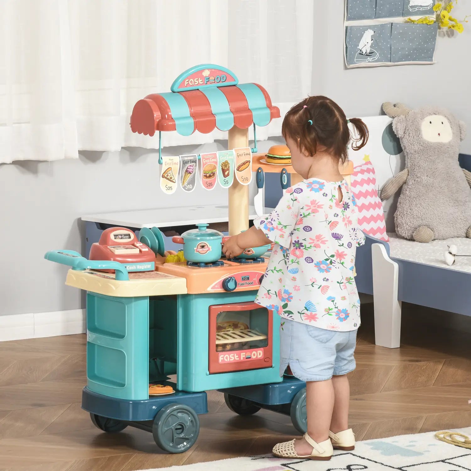 Un ensemble de cuisine pour enfants en plastique turquoise et orange, avec une caisse enregistreuse sur un chariot de cuisine de jeu pour restauration rapide à roues, comprenant 50 pièces.