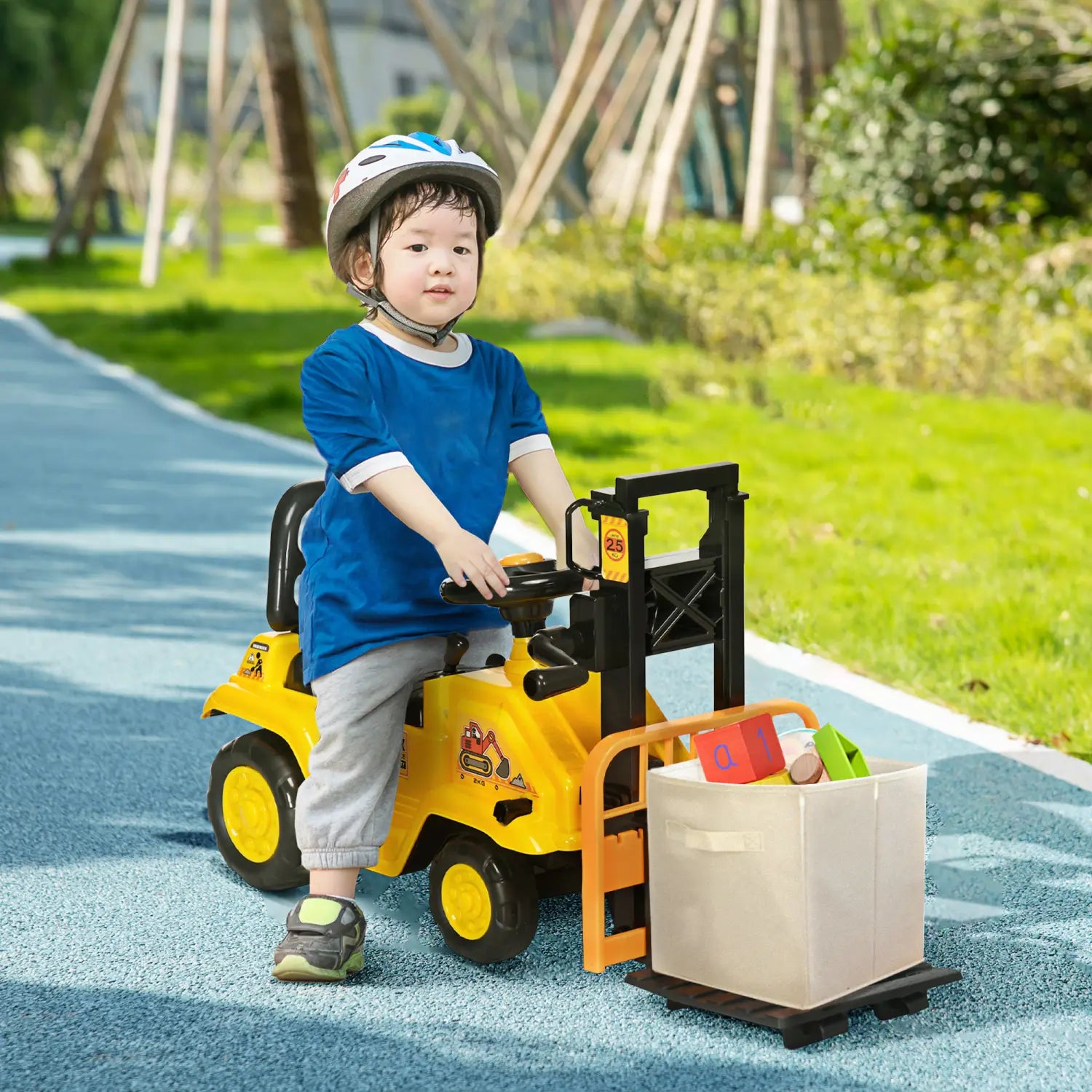 Yellow plastic ride-on forklift toy for kids with black handle, orange forks, and carrying a beige storage bin, featuring storage and horn functions.