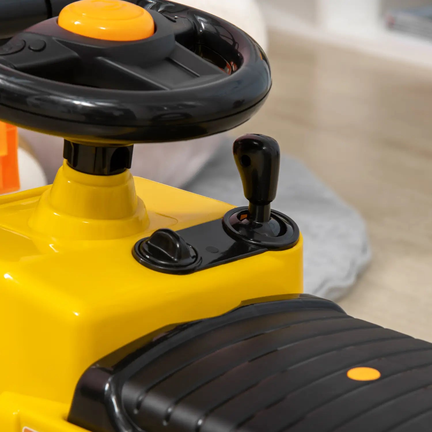 Yellow and black plastic ride-on forklift toy for kids with a steering wheel, gear shift lever, textured seat, storage, and horn.