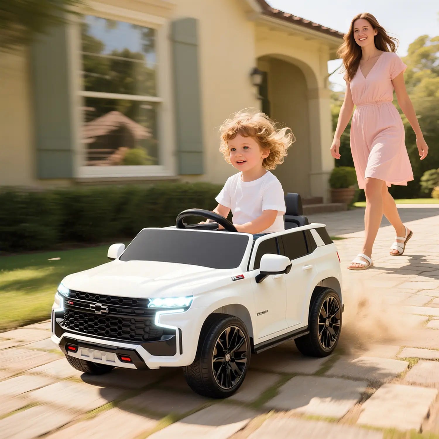 White 12v kids electric ride on Chevrolet toy SUV with black accents and chrome detailing.