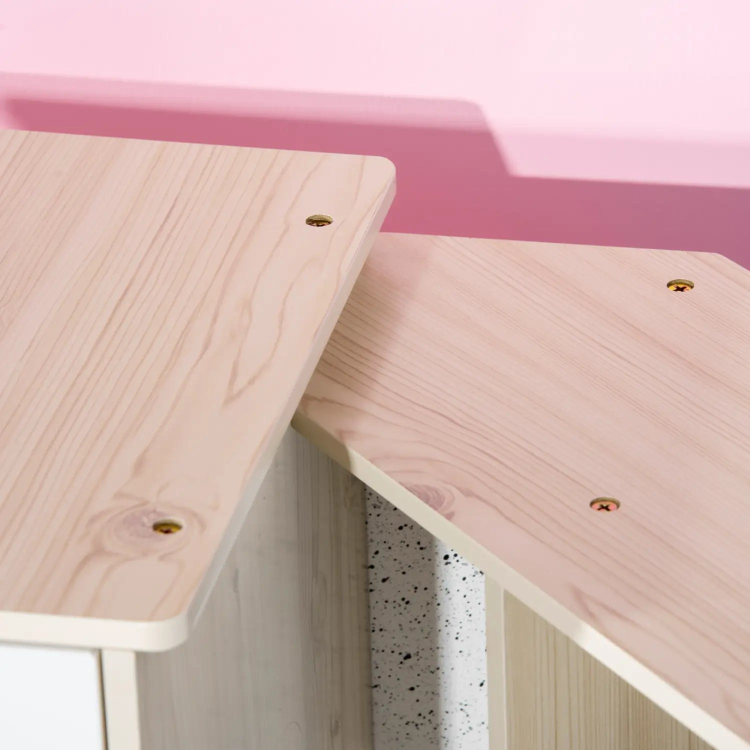 light-colored wooden desk panels with visible grain and gold-toned screws on the kids wooden kitchen playset with sound effects and toys