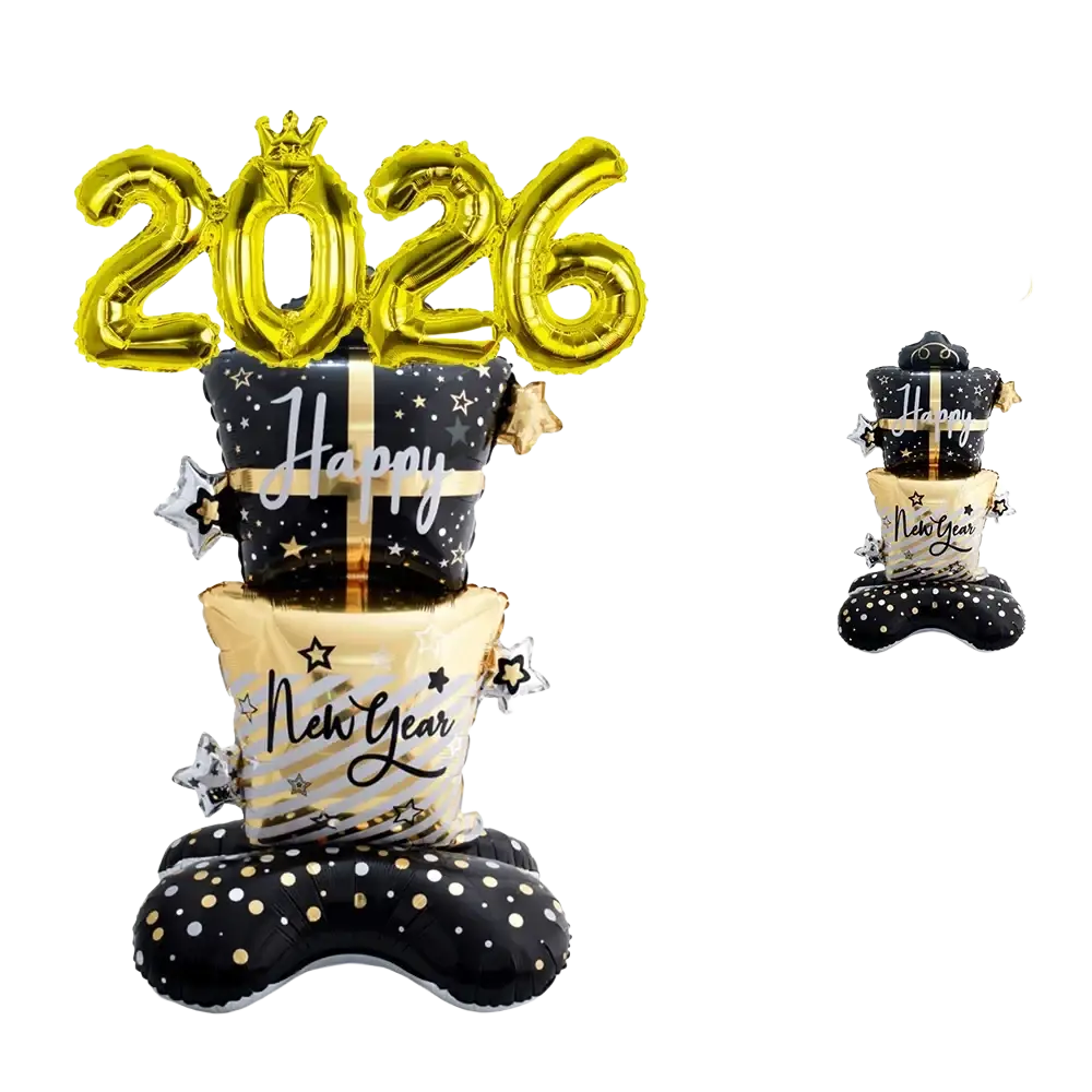 Gold foil balloon centerpiece shaped like stacked gift boxes with happy new year text and star decorations for 2026 celebration