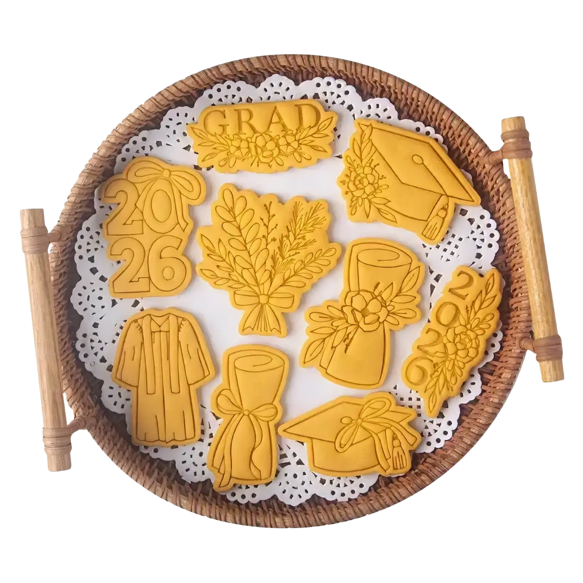 Golden metal 2026 graduation cookie cutter set arranged on a woven tray for celebration baking purposes