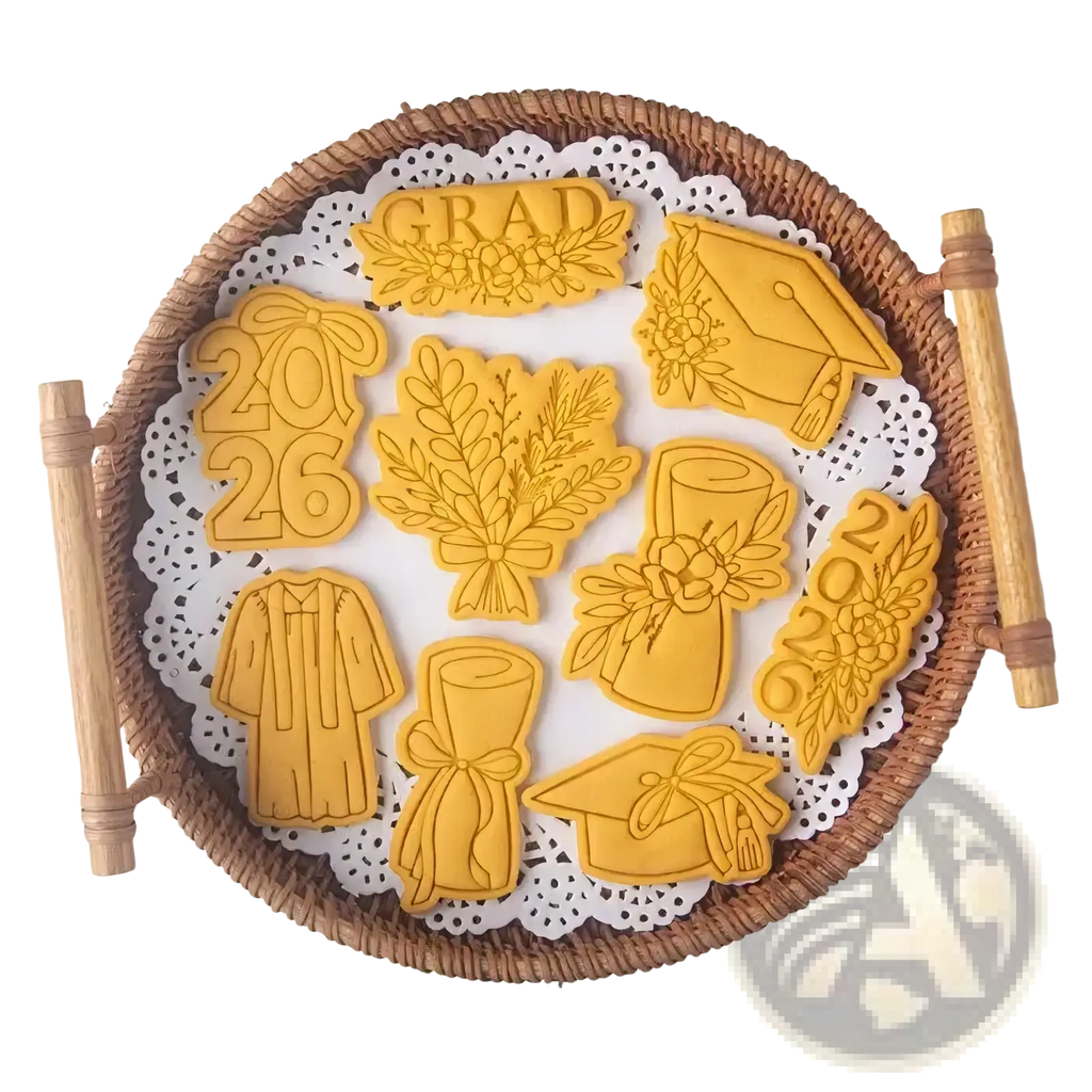 Golden 2026 graduation cookie cutter set features caps gowns diplomas shaped sugar cookies arranged on woven basket