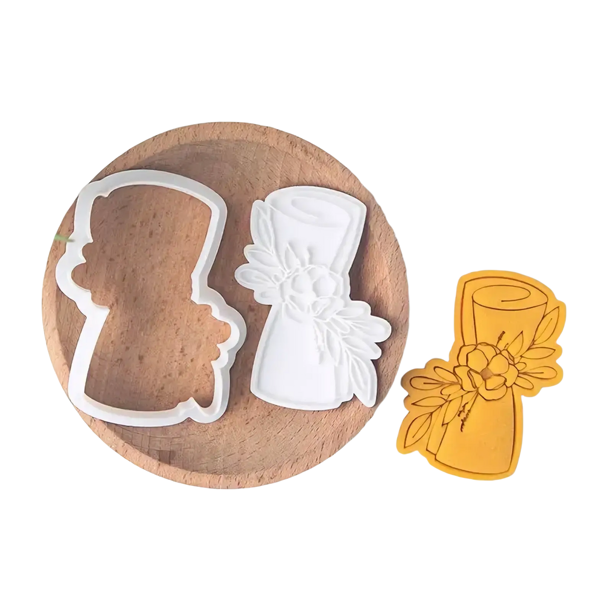 White plastic cookie cutter shaped like a wedding bouquet with floral details from 2026 graduation cookie cutter set