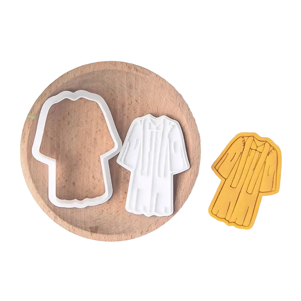 White plastic graduation gown cookie cutter with detailed pleats and collar design from 2026 graduation cookie cutter set
