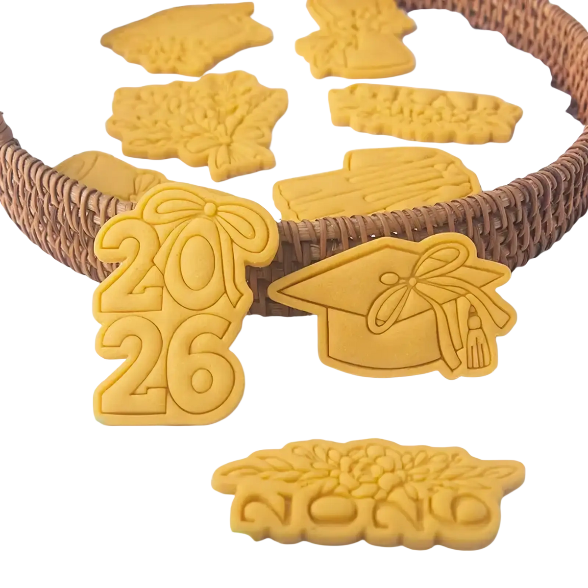 Yellow plastic 2026 graduation cookie cutter set featuring caps tassels and year designs for themed baking