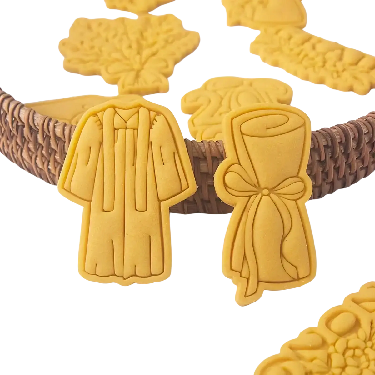 Yellow 2026 graduation cookie cutter set featuring gown and diploma-shaped baked dough cookies for celebration use