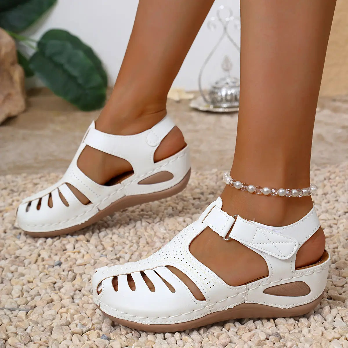 Sandales compensées en cuir blanc pour femmes, avec design de bride T et détails découpés, idéales pour des chaussures d’été au style romain.