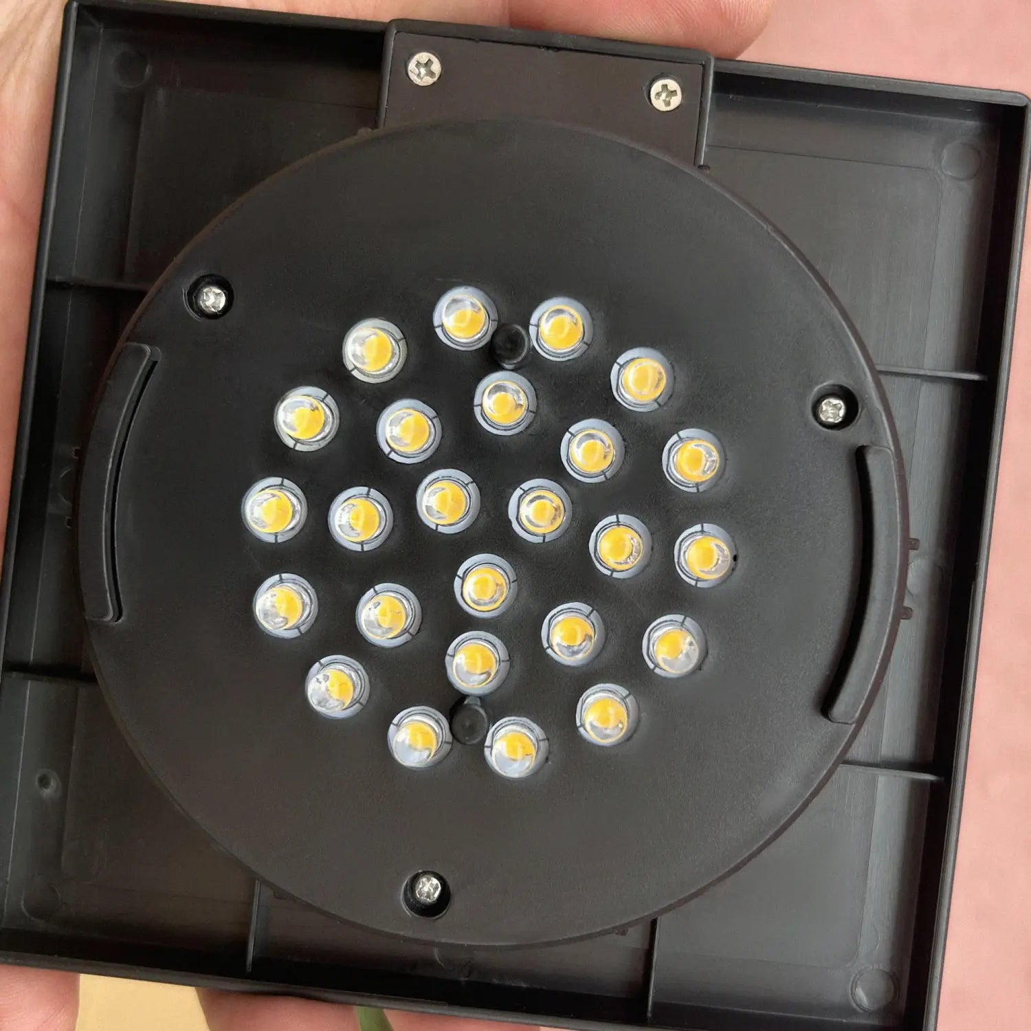 Black circular solar floor lamp outdoor rattan garden path light with 24 bright yellow LEDs arranged in a grid pattern.