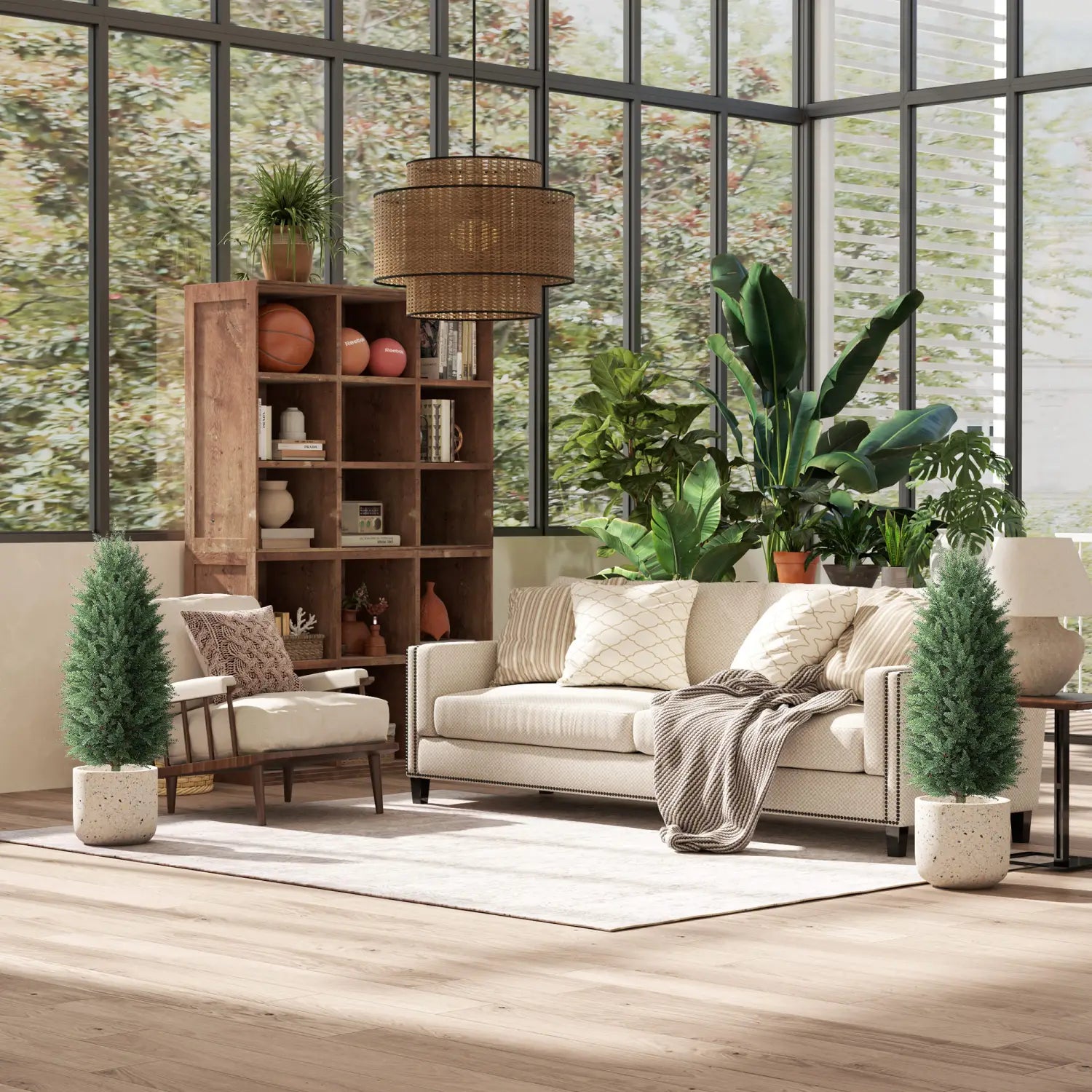 beige upholstered sofa with nailhead trim and patterned throw pillows positioned next to a set of two 43 inch artificial cypress topiary trees.