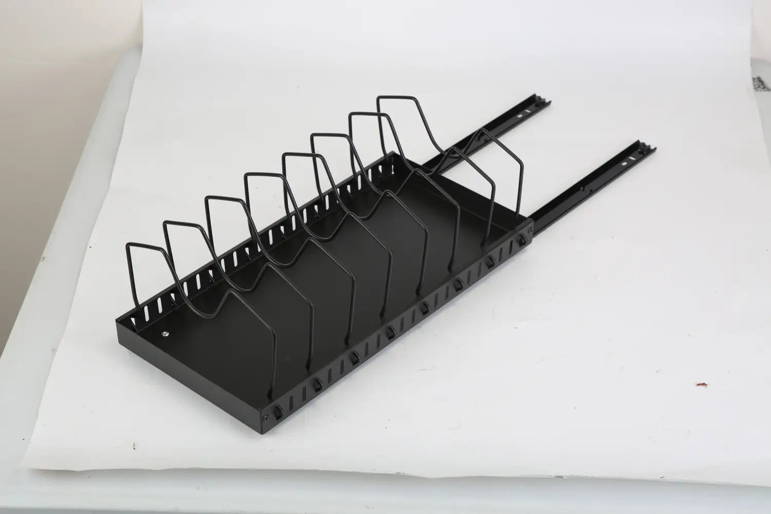 Black metal pull out pots and pans organizer with 8 dividers and multiple slots for cable management and wire organization.
