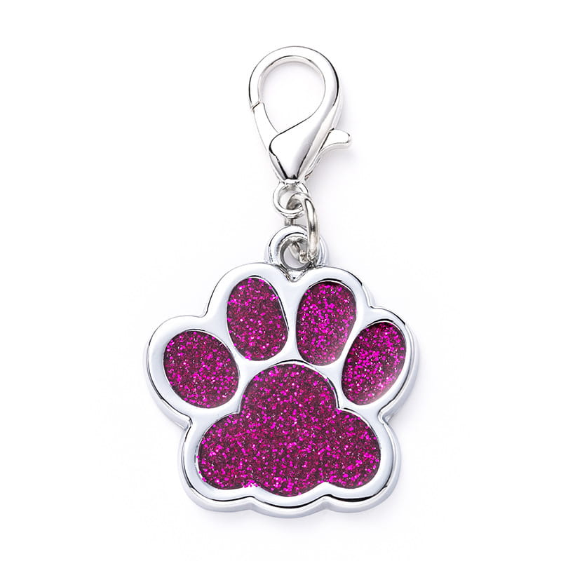 A shiny silver metal dog tag shaped like a paw print with a vibrant pink glitter-filled center and a secure clasp at the top.