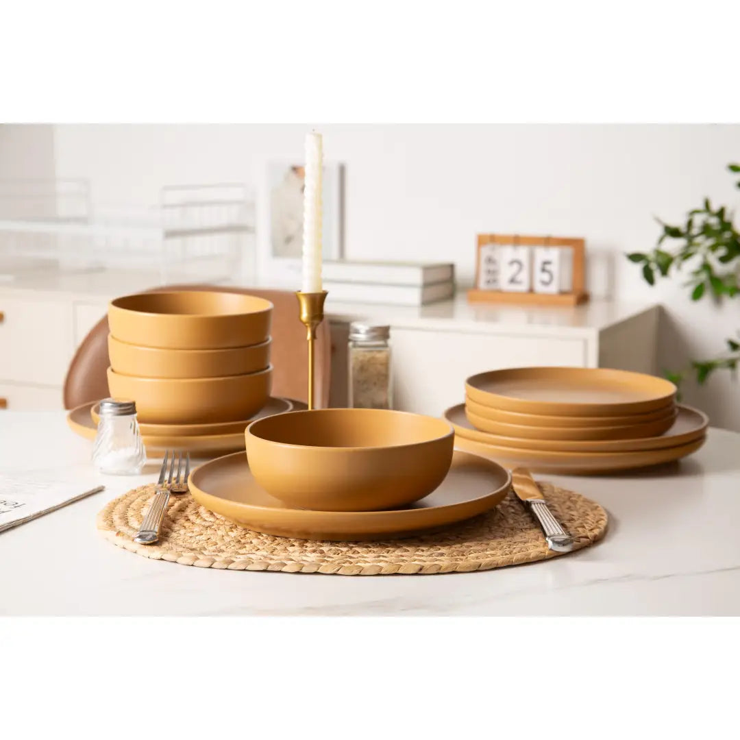 Warm-toned stoneware dinnerware set with smooth matte glaze and subtle rim detailing in a 12 piece set for four.