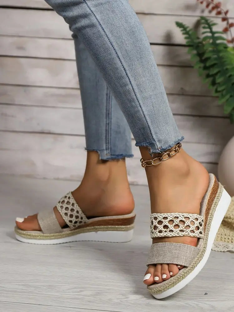 Beige women’s mesh espadrille platform wedge sandals with woven straps, a textured espadrille sole, and a white rubber heel.