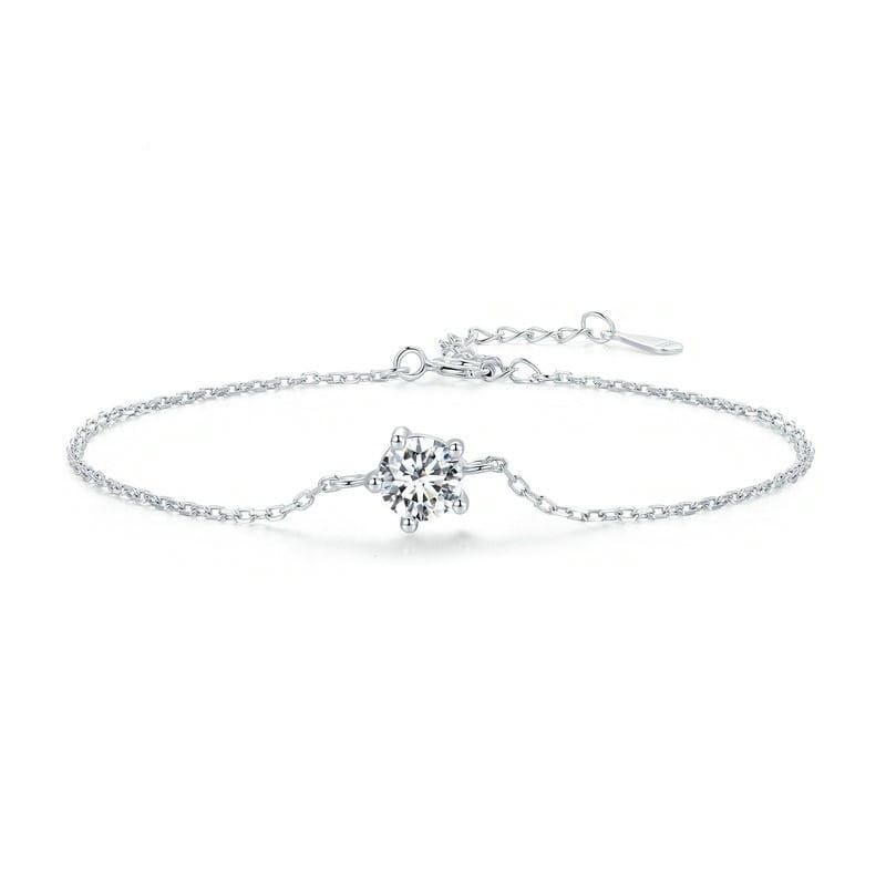 A delicate silver chain bracelet featuring a central solitaire moissanite diamond in a four-prong setting.