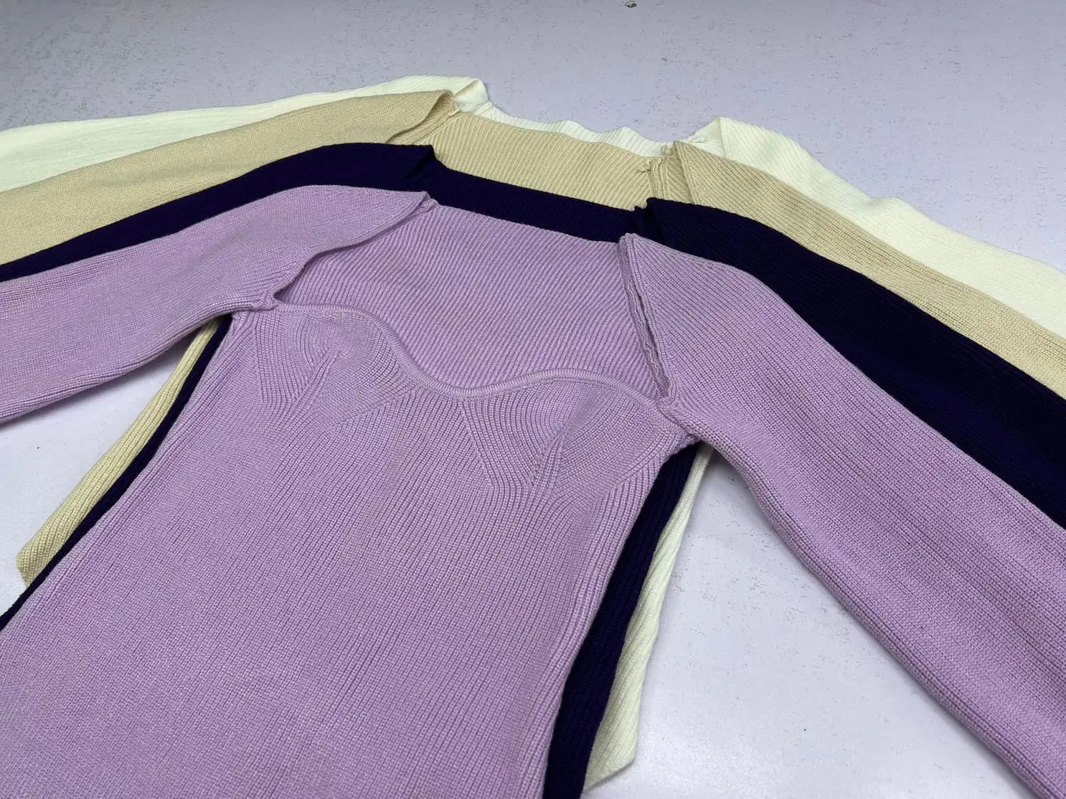 A lavender ribbed knit long sleeve pullover with a sweetheart neck and contrasting cream and navy stripes along the shoulders sleeves and sides.