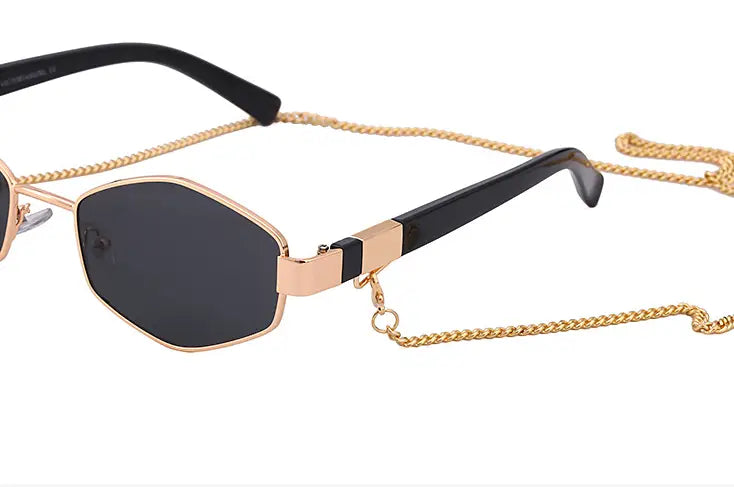 women’s sunglasses with gold-toned chain accent, black octagonal frames, and dark gradient lenses.