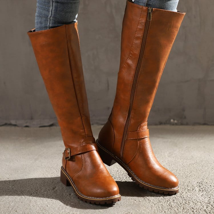 Braune Knielappenstiefel aus Leder mit goldfarbenem Schnallenriemen und Reißverschlussverschluss, mit niedrigem Absatz.