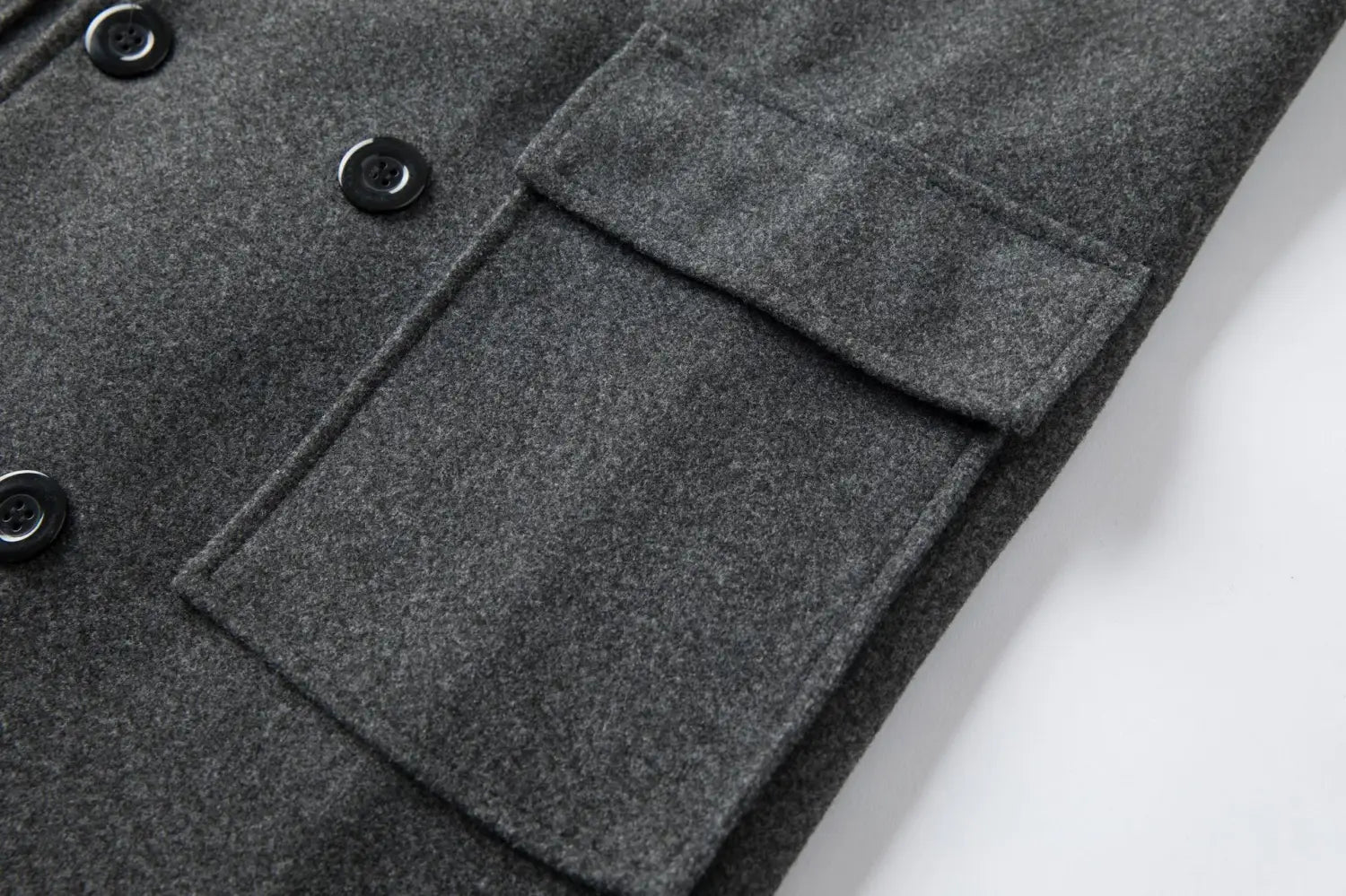 Men double breasted dark gray wool overcoat featuring black buttons and a flap pocket in a mid length design.
