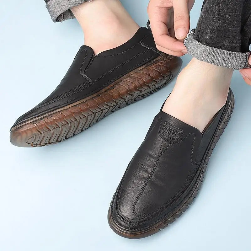 Men’s breathable non slip gray leather slip-on loafers with textured sole and visible stitching.