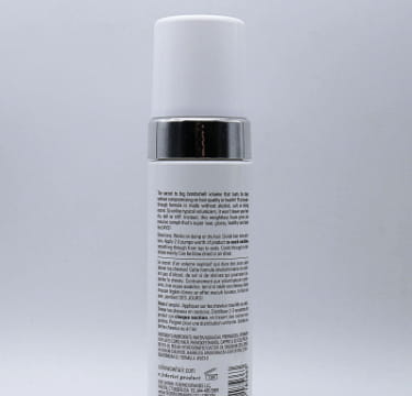 white cylindrical spray bottle with silver cap and black label of color wow xtra large bombshell volumizer hair mousse shown from the front