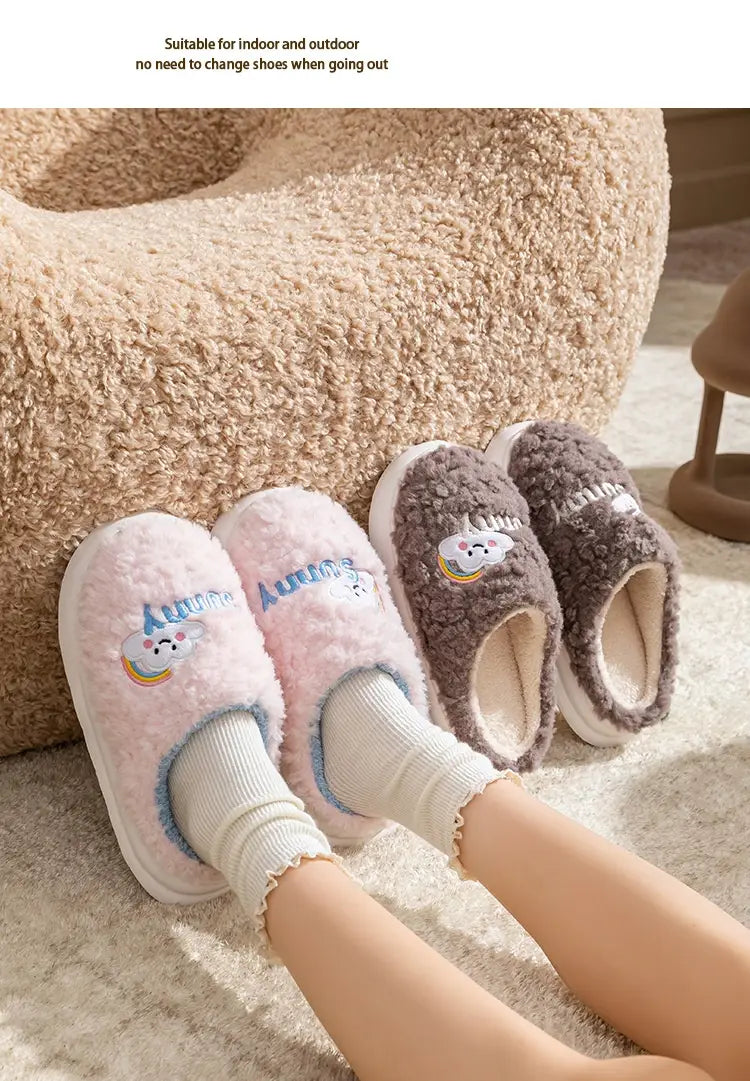 Pink and gray fluffy slip-on plush cotton slippers featuring smiling cloud and rainbow embroidery.