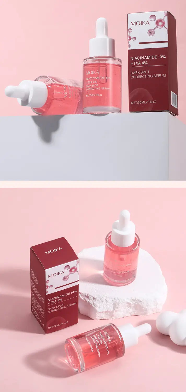 pink liquid-filled serum bottles with white dropper caps and red packaging labeled moika niacinamide 10% txa 4% for dark spot correcting serum 30ml