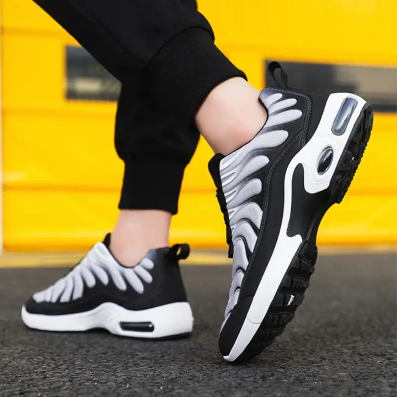 Black and white high-top air cushion running shoes featuring a distinctive flame-like pattern on the side and visible air cushioning units in the heel and midsole.