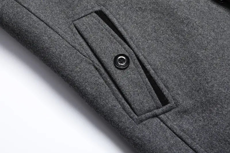 gray wool pocket with a black button on a men wool winter overcoat quilted jacket