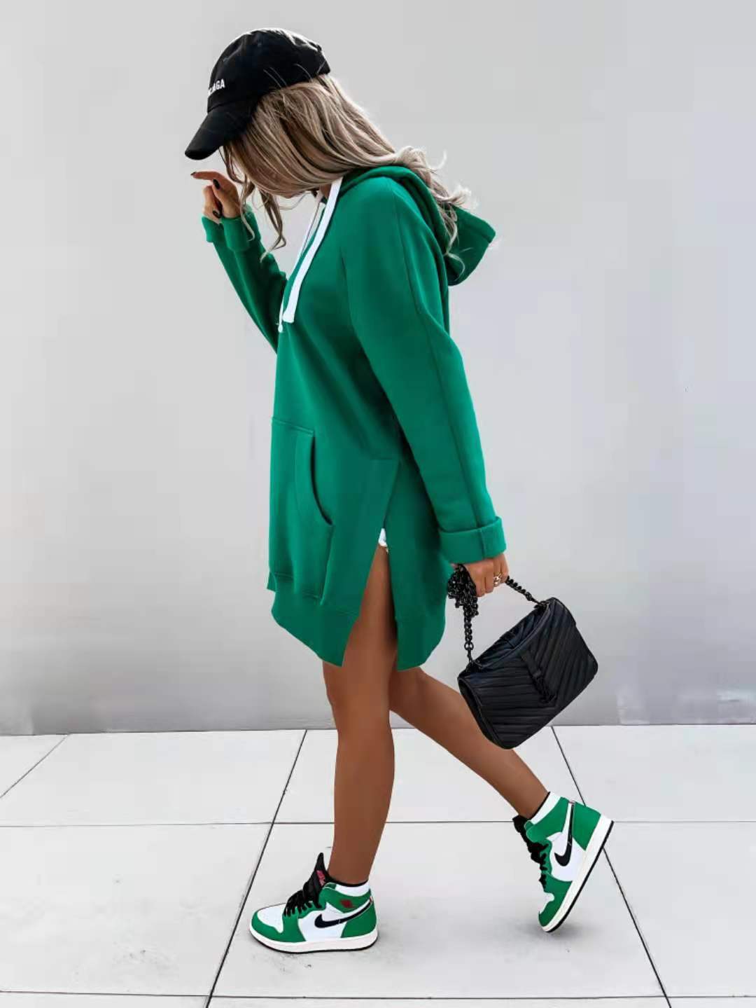 green oversized mid length hooded sweatshirt dress with white drawstrings, side slit, and pockets made from soft fabric