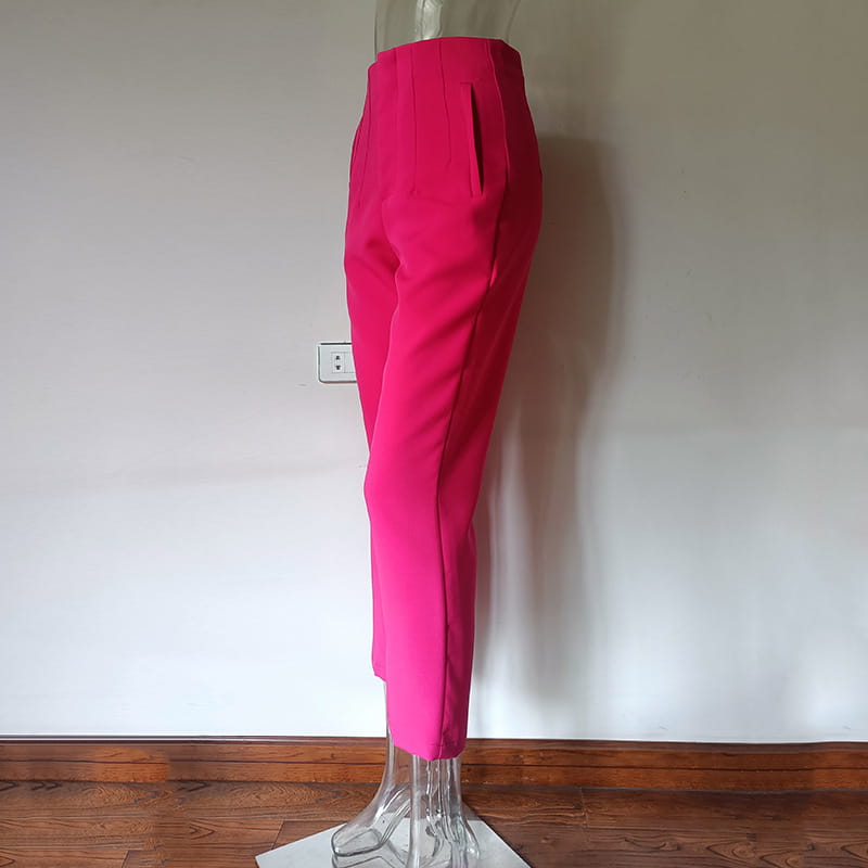 Pantalon taille haute à plis plats et jambes droites fuchsia vif, avec une coupe soignée et des plis discrets.