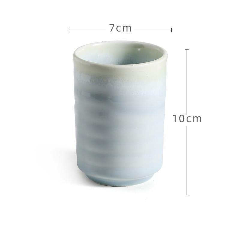 Japanese ceramic mug 250ml featuring a slender 7cm wide and 10cm tall design with a soft celadon glaze and subtle horizontal ridges for hand-painted tea use.