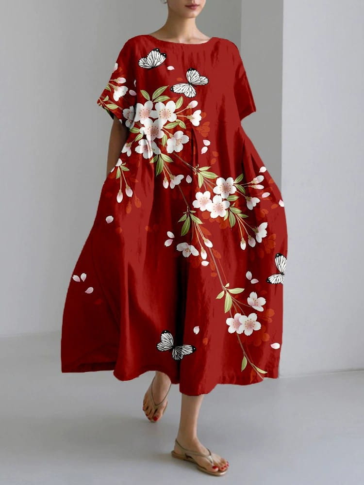 Artistic printed loose linen maxi dress in red with delicate white cherry blossoms and black and white butterflies on lightweight fabric.