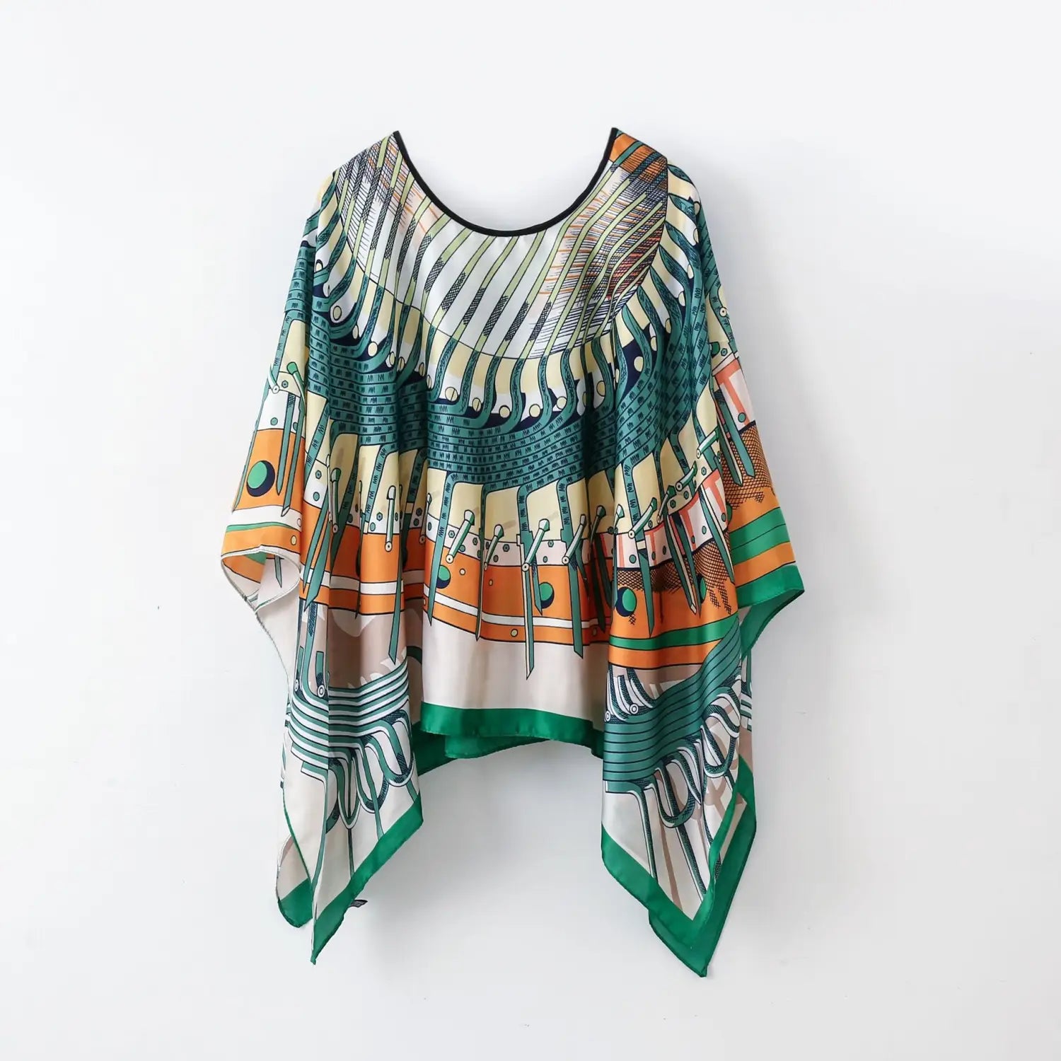 A flowing, wide-sleeved printed silk patterned pullover shawl cape outerwear in vibrant teal, orange, and cream geometric tones.