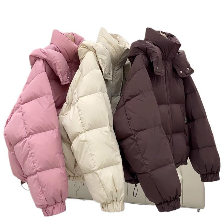 Three women puffer jackets in pastel pink, cream, and dark brown with quilted designs and hooded collars suitable for winter wear.