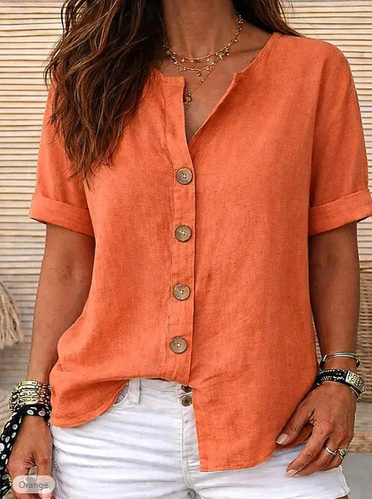 A soft orange linen short sleeve button up cardigan for women with a button-down front.
