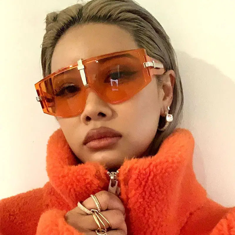 Orange translucent rectangular vintage shield uv400 futuristic oversized sunglasses with silver metallic frame accents.