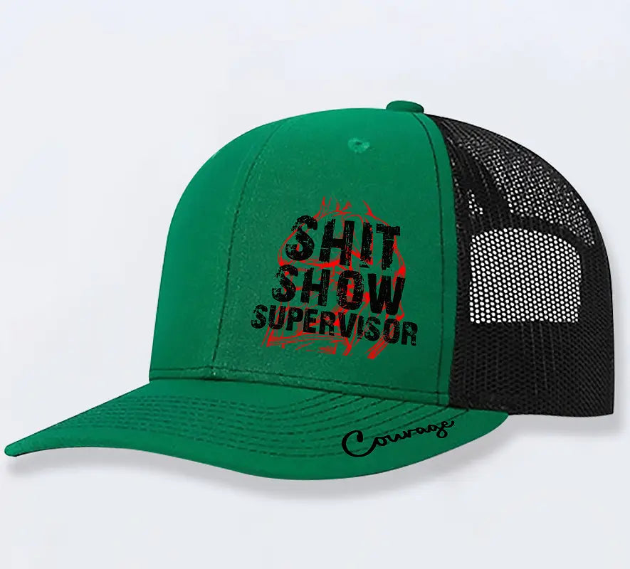 Green and black trucker hat for men with shit show supervisor printed in bold black letters over a red flame design and the word courage scripted on the brim.