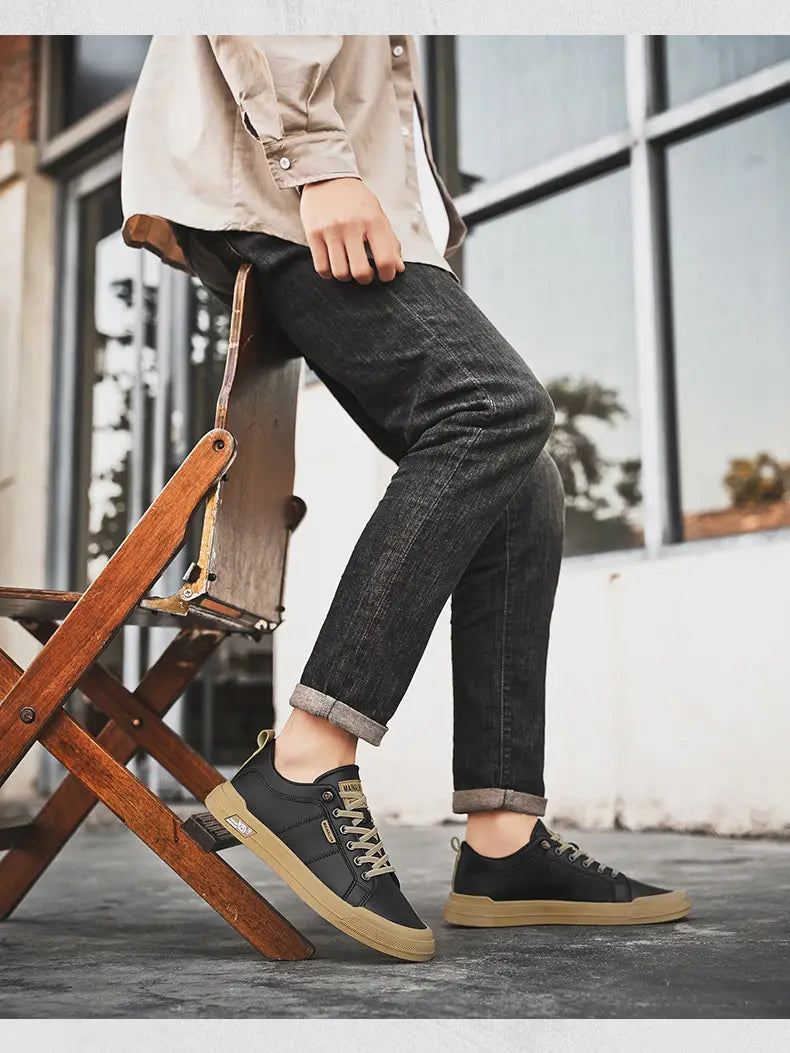 black canvas sneakers with tan rubber soles and matching laces featuring a minimalist design for men’s casual wear