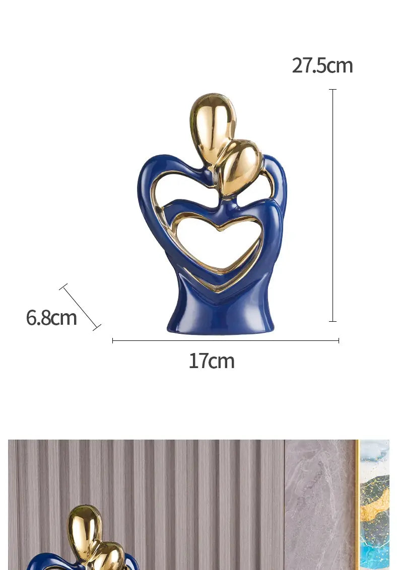 Blue and gold ceramic figurine of two abstract figures embracing in a heart-shaped form for modern home decor.